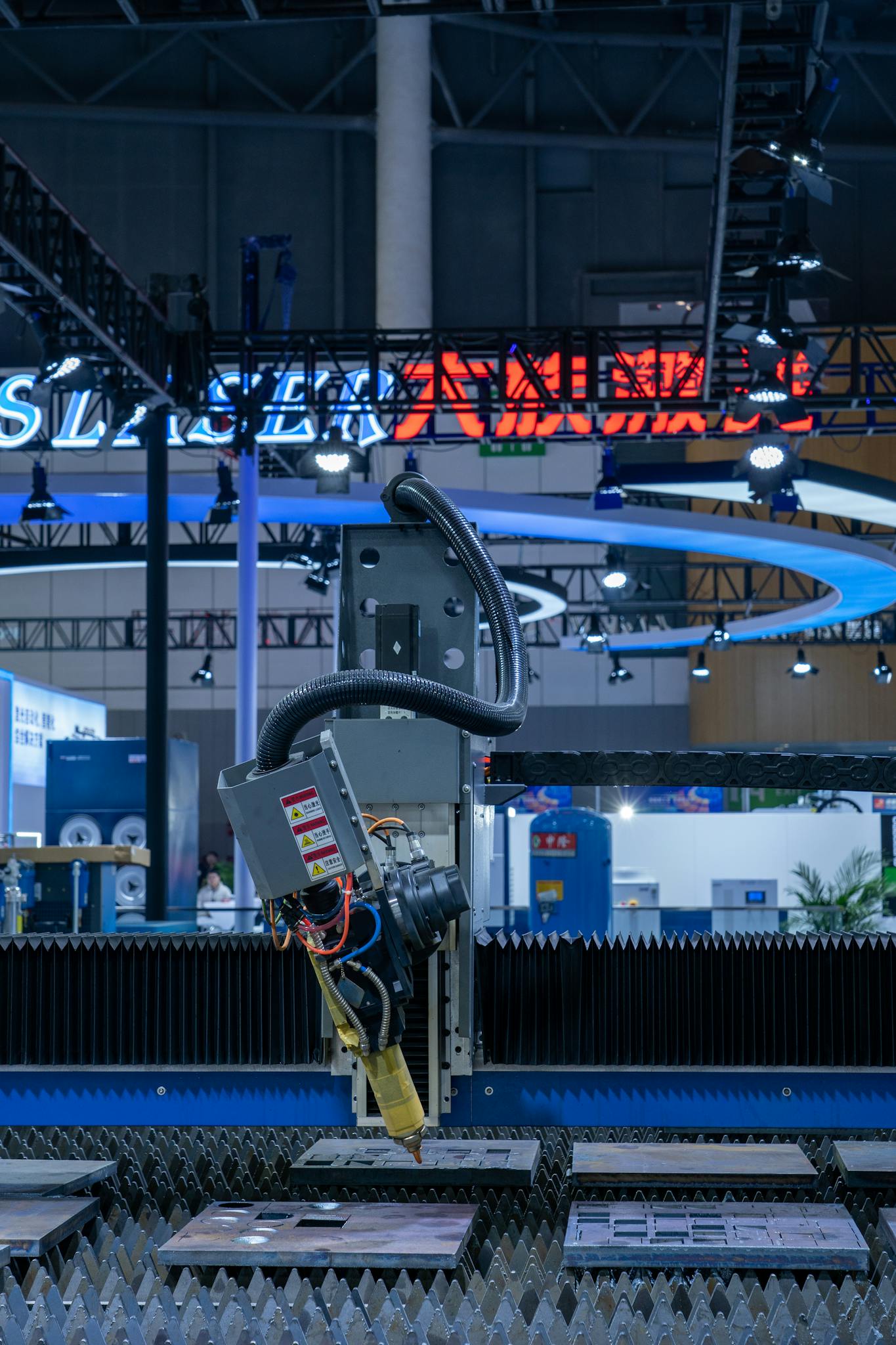 Close-up of a laser cutting machine at an industrial exhibition showcasing advanced technology.